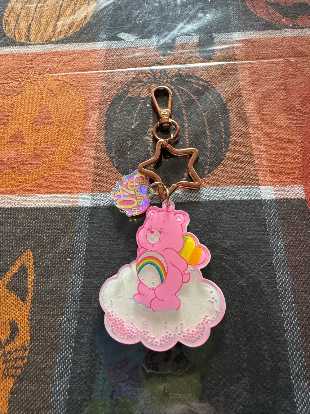 Well loved Shein Carebear keychain featuring cheer bear